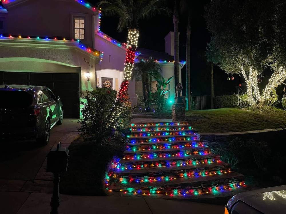 Holiday lighting along an entry staircase